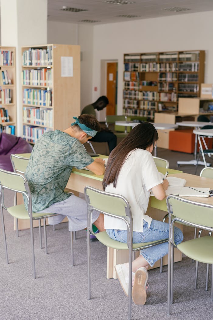 Adult students studying in a cozy university library environment, focusing on learning.